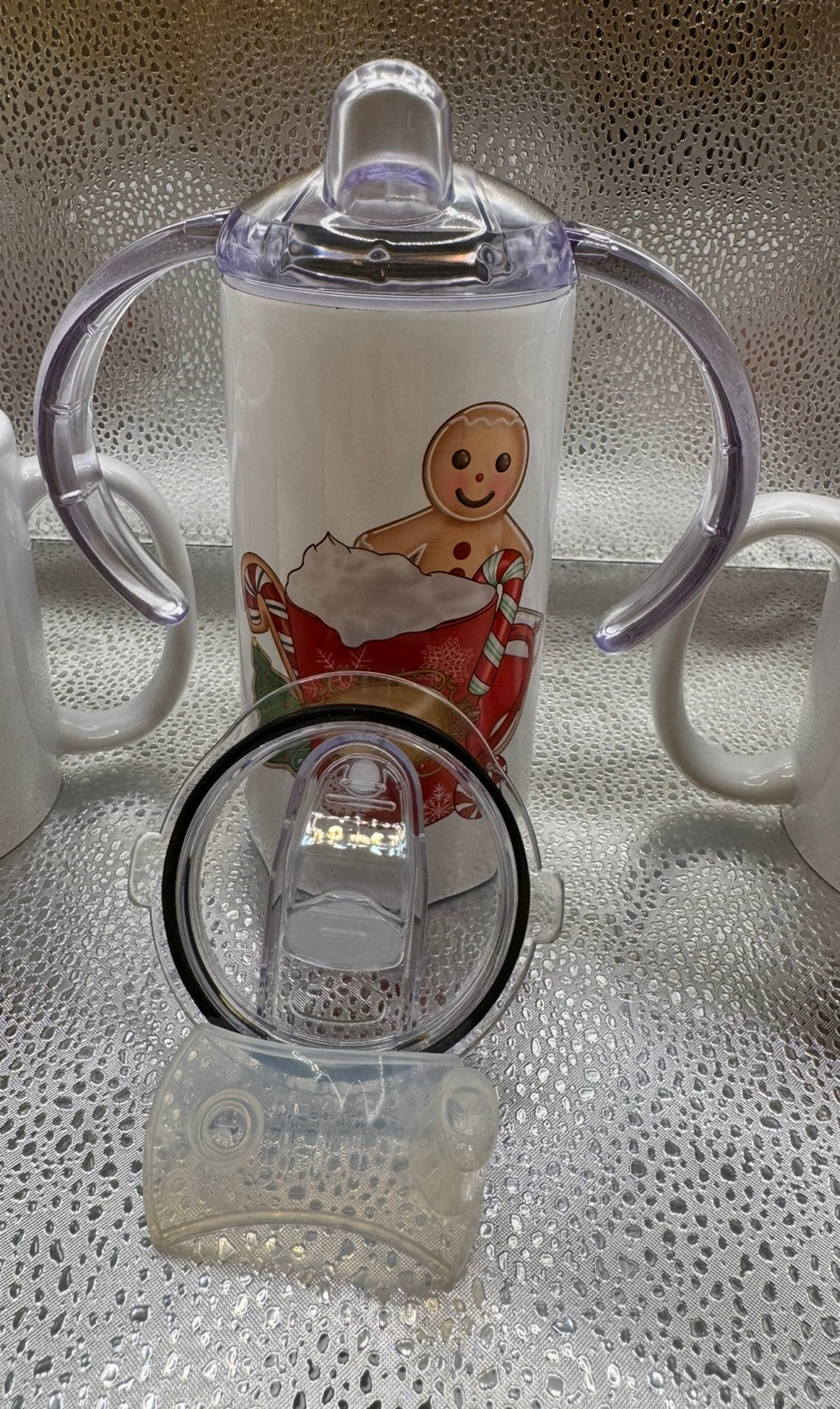 Child’s sippy cup with several lids and straw