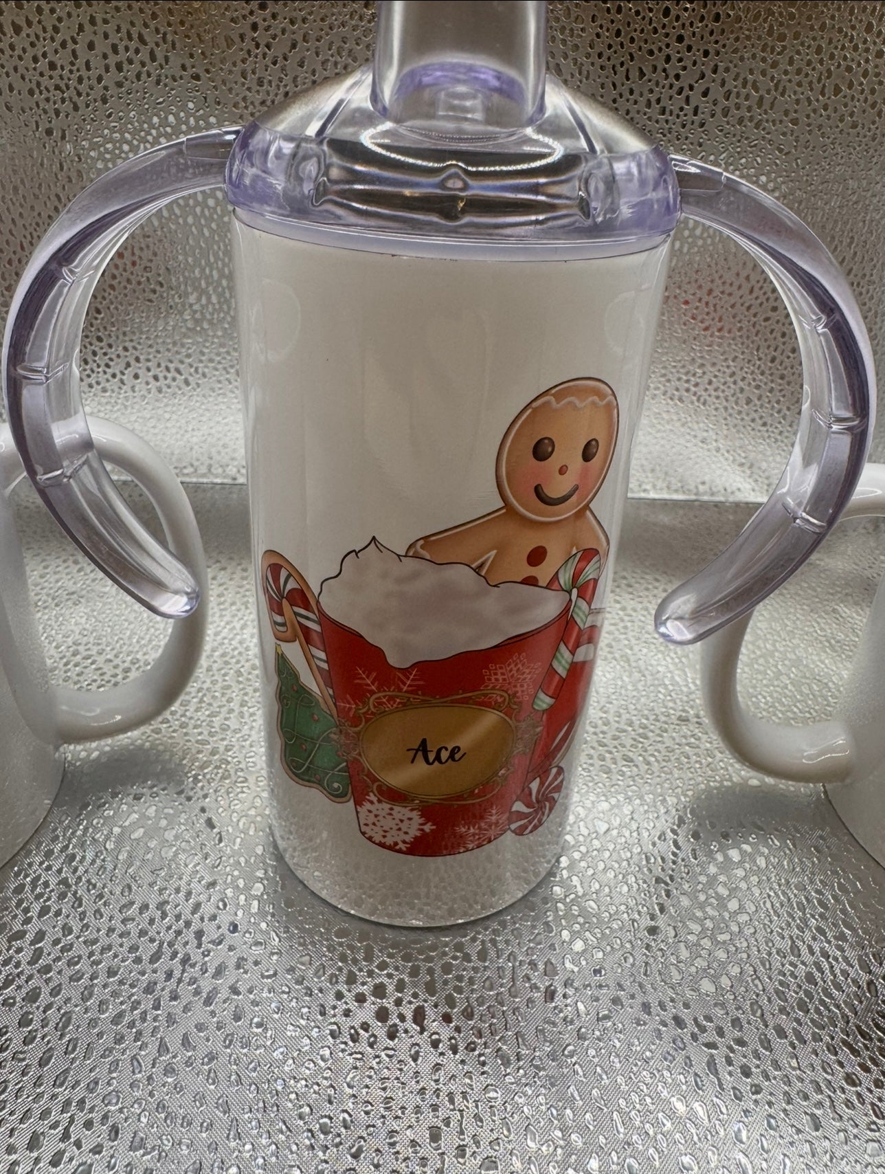 Child’s sippy cup with several lids and straw